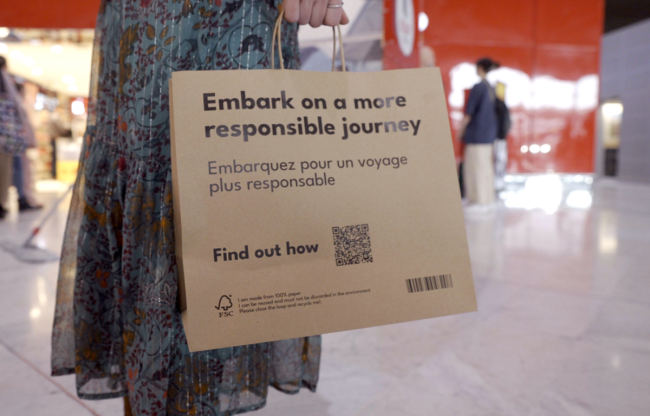 Paper bag with inscription "Embark on a more sustainable journey"