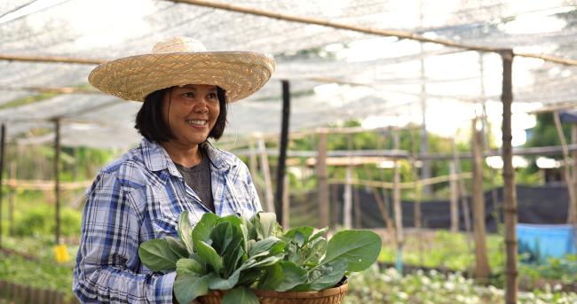 Woman holding a basket of salad